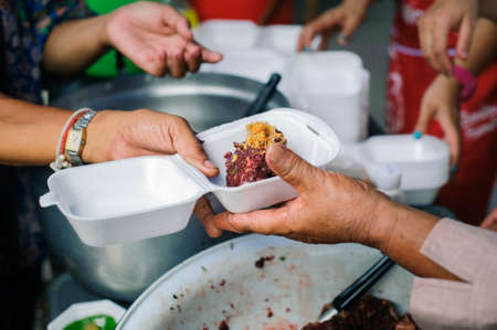 Food sharing in human societies can help homeless people : concept Sharing Food With Homelessの写真素材