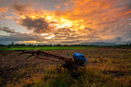 The rice fields and tractors of the villagers prepare to grow rice in the rainy seasonの写真素材