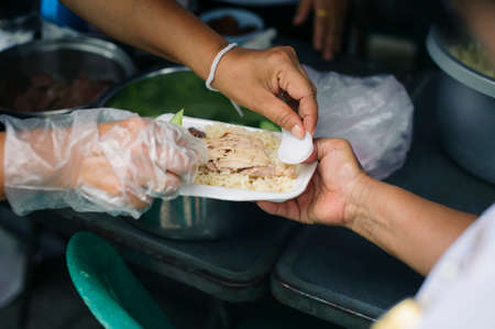 concepts of poverty in Asian society : Volunteers Share Food to the Poor to Relieve Hungerの写真素材