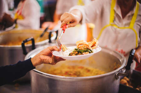 Food sharing with the homeless in society : concept of famine and charity foodの写真素材