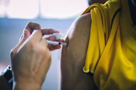 The doctor vaccinated the patient : concepts of disease prevention and medical treatmentの写真素材