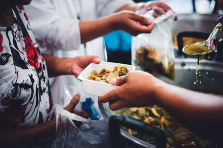 The hand of the poor receives food from the hand of the giver : concept of helping with feeding