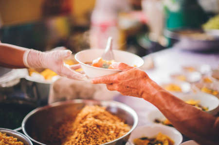 Volunteers give away free food to hungry people : concept of care And feeding