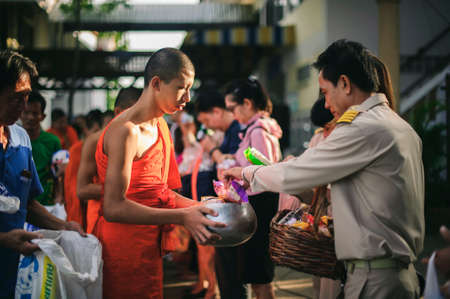 Chiang Mai, Thailand - OCTOBER 23, 2019: State enterprise employees in Saraphi District jointly offer food, drinks to Buddhist monks in Saraphi, Chiang Maiのeditorial素材