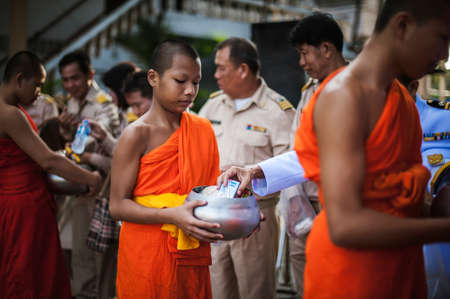 Chiang Mai, Thailand - OCTOBER 23, 2019: State enterprise employees in Saraphi District jointly offer food, drinks to Buddhist monks in Saraphi, Chiang Maiのeditorial素材