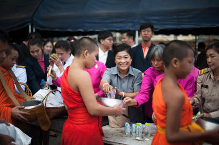Chiang Mai, Thailand - OCTOBER 23, 2019: State enterprise employees in Saraphi District jointly offer food, drinks to Buddhist monks in Saraphi, Chiang Maiのeditorial素材