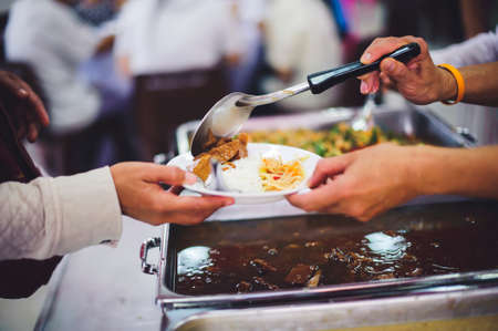 Compassion in human society leads to free food donations to the poor: poor people still need food, concept of feeding to the poorの写真素材