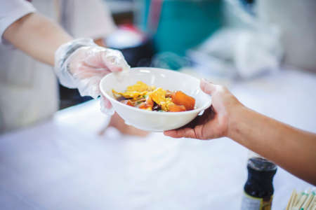 Difficult people receive free food from philanthropy through volunteers: concept of feeding and...