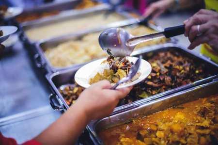Refugee's Hands Receive Food with Starvation from a Donor's Food of Philanthropists : Concept of...