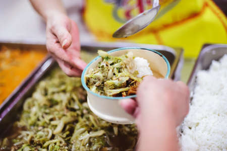Refugees' hands are receiving food from philanthropists: the concept of hunger problems for the poor