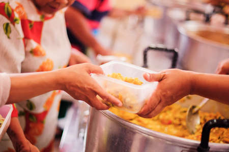 The concept of giving : donating food to the homelessの写真素材