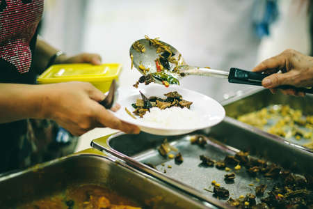 The society of sharing: the hands of donors requesting food from generous people: concept of givingの写真素材