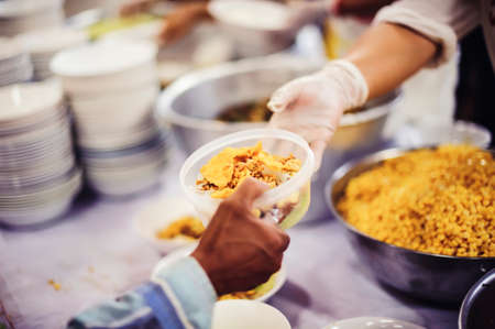 Food Sharing Society: Volunteers are sharing food to hungry people in society.