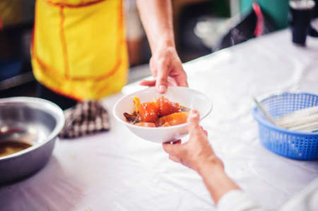 Homelessness and hunger : helping by donating food to the poorの写真素材