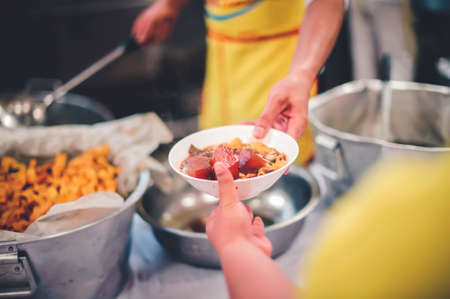 Homeless people receive free food from compassionate people: the concept of food needs