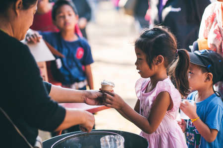 Chiang Mai, Thailand - JANUARY 11, 2020: Energetic Thai children join National Children's Day activities, receiving many prizes Including receiving food and beverages in Saraphi, Chiang Maiのeditorial素材