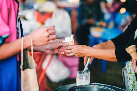 The hands of the poor are waiting to receive food from the rich, compassionate, free food donations...