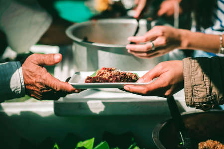 Feeding the poor to hands of a beggar, Poverty concept
