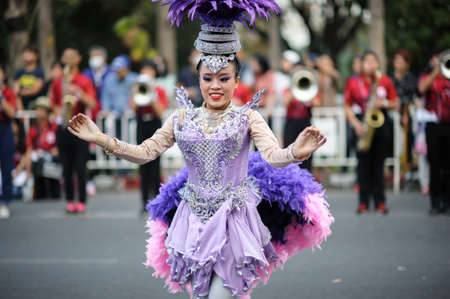 CHIANG MAI, THAILAND - FEBRUARY 08, 2020: The dancing lady in beautiful traditional clothes danced with delicacy in the 44th flower festival parade in Chiang Mai, Thailandのeditorial素材