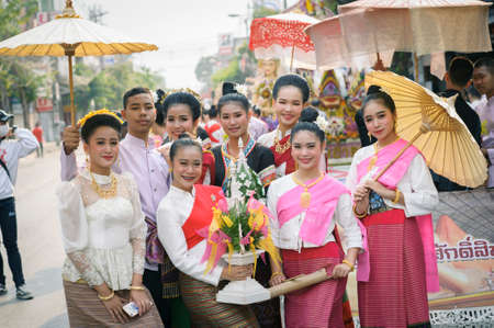 CHIANG MAI, THAILAND - FEBRUARY 08, 2020: Young men and women dressed in traditional clothe in the 44th flower festival parade in Chiang Mai, Thailandのeditorial素材
