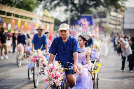 CHIANG MAI, THAILAND - FEBRUARY 08, 2020: Cyclists take tourists to the parade at the 44th flower...