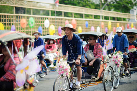 CHIANG MAI, THAILAND - FEBRUARY 08, 2020: Cyclists take tourists to the parade at the 44th flower...