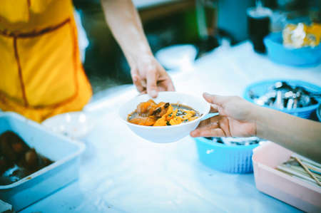 The concept of helping by providing food to the needy in the community.の写真素材