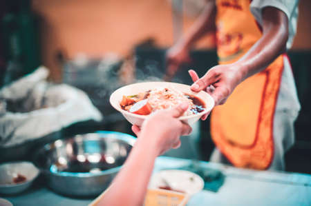 Volunteers Share Food to the Poor to Relieve Hunger, Charity food conceptの写真素材
