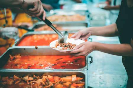 Providing food to the poor and helping with food , concept serving free food to the poor
