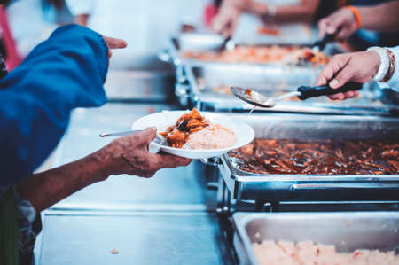 Concept of free food serving : Starvation issues help with food donationsの写真素材