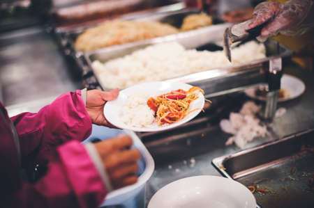 Helping with food donation to the poor: the concept of feedingの写真素材