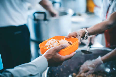 Helping with food donation to the poor: the concept of feedingの写真素材