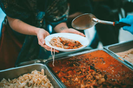 Feeding to the poor to hands of a beggar : concept of feeding food for beggarの写真素材