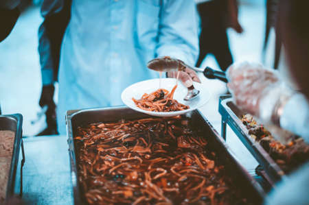 Volunteers give food to the poor : donating food is helping human friends in societyの写真素材