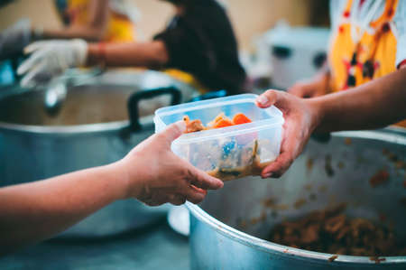 Sharing Food With Homeless : Free food for the poor and Food distributionの写真素材