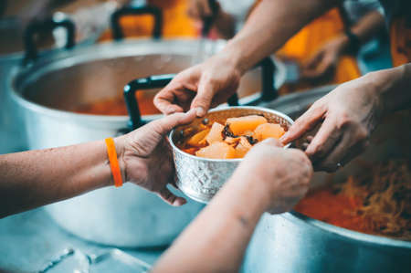 Concept of feeding : Sharing food with people in poor communities