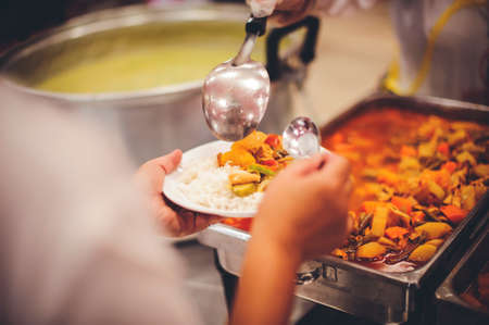 The hands of the poor receive food from the hands of the philanthropist : concept of givingの写真素材