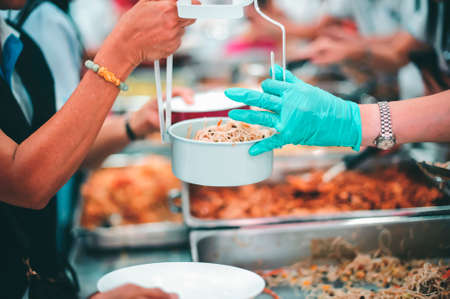 The hands of the poor receive food from the hands of the philanthropist : concept of givingの写真素材