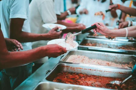 Poverty concept : Feeding the poor to hands of a beggar