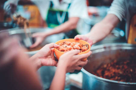 The hands of beggars receive donated food : The concept of food shortagesの写真素材