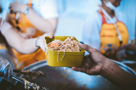 The hands of beggars receive donated food : The concept of food shortagesの写真素材