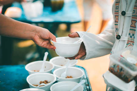 Donate food to the poor : concept Sharing Food With Homelessの写真素材