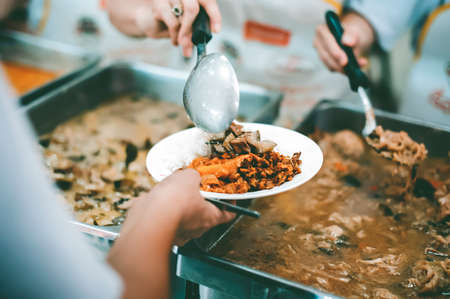 Donate food to the poor : concept Sharing Food With Homelessの写真素材