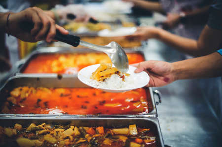 concepts of poverty : Volunteers Share Food to the Poor to Relieve Hungerの写真素材
