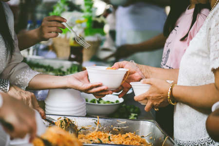 concepts of poverty : Volunteers Share Food to the Poor to Relieve Hungerの写真素材