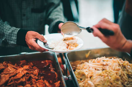 The concept of human hunger : Volunteers donate free charity food to the homelessの写真素材