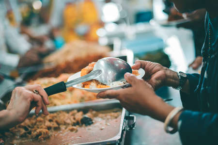 concepts of poverty : Volunteers Share Food to the Poor to Relieve Hungerの写真素材