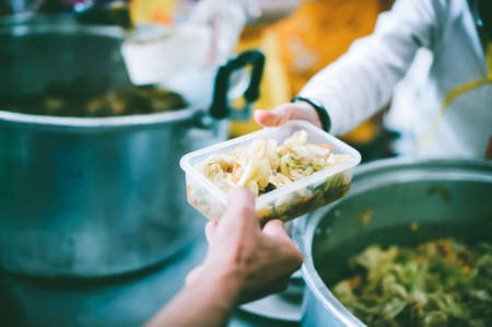 Charity food concept : Volunteers Share Food to the Poor to Relieve Hungerの写真素材