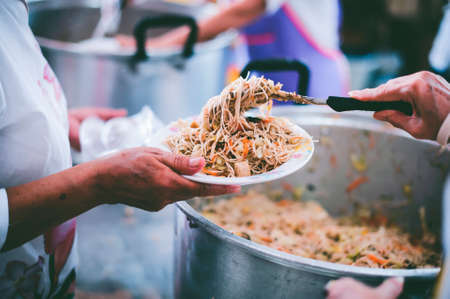 Charity food concept : Volunteers Share Food to the Poor to Relieve Hungerの写真素材