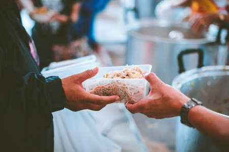 Concept of feeding and sharing : Providing free food for the poor hungerの写真素材